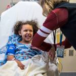 Kaya Sanders, 5, smiles as she gets her vitals checked during a radiology appointment at Seattle Childrens Hospital on Wednesday. (Olivia Vanni / The Herald)