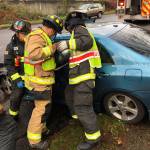 Firefighters with South Snohomish County Fire & Rescue work to remove a patient from of a crashed car Sunday, Dec. 23 in Lynnwood. (South Snohomish County Fire & Rescue)