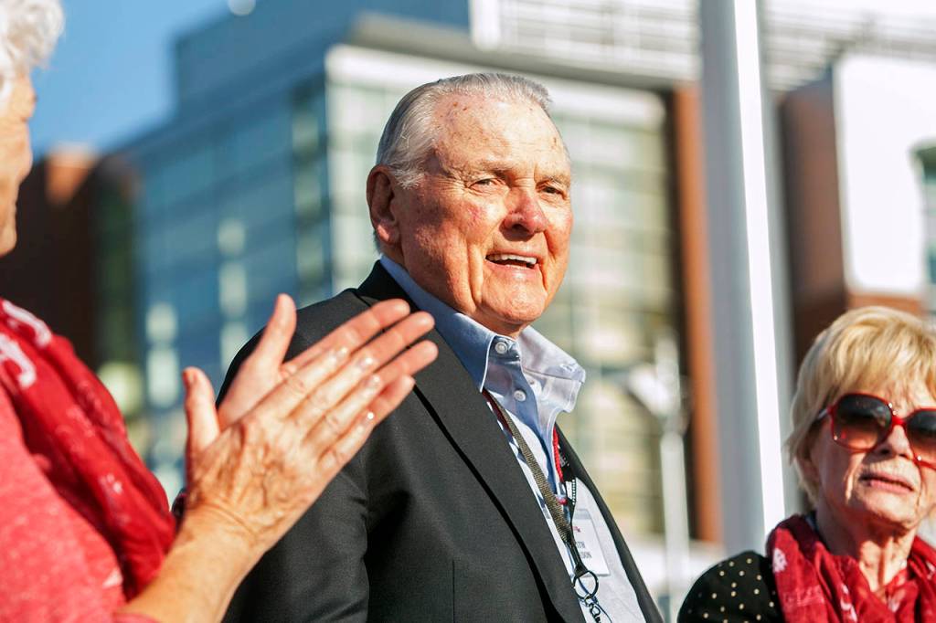 In this Sept. 13, 2014, photo, Washington State alumnus Keith Jackson smiles after raising the Cougar flag before the start of an NCAA college football game against Portland State at Martin Stadium in Pullman, Washignton. Jackson, the down-home voice of college football during more than five decades as a broadcaster, died Jan. 12, 2018. He was 89. (AP Photo/Dean Hare, File)