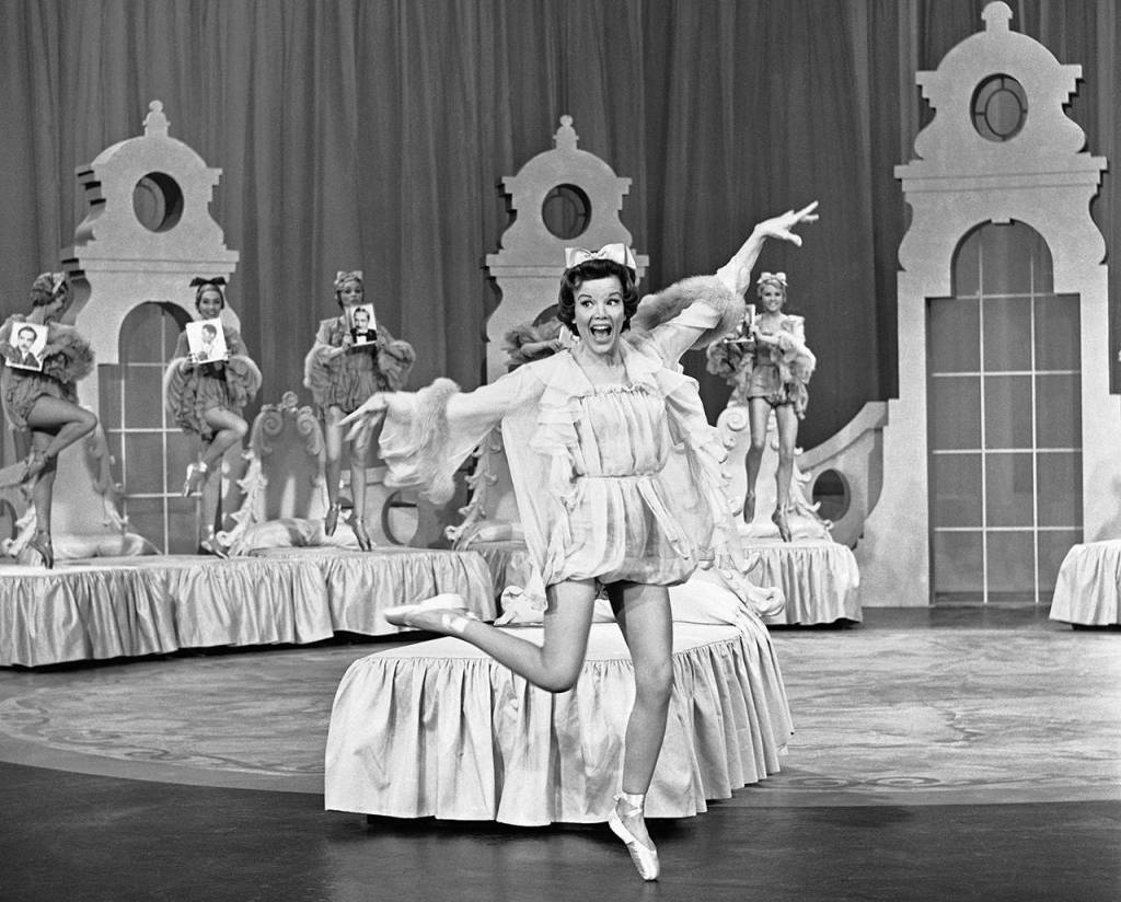 Nanette Fabray sings If I Had A Talking Picture of You, joined by dancers, against a background of typical plush setting of early musicals on Feb. 26, 1962. (AP Photo/David F. Smith, file)