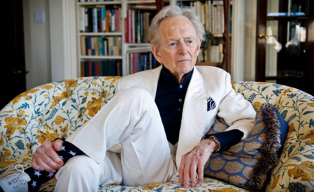 In this July 26, 2016 photo, American author and journalist Tom Wolfe, Jr. appears in his living room during an interview about his latest book, The Kingdom of Speech, in New York. (AP Photo/Bebeto Matthews, File)