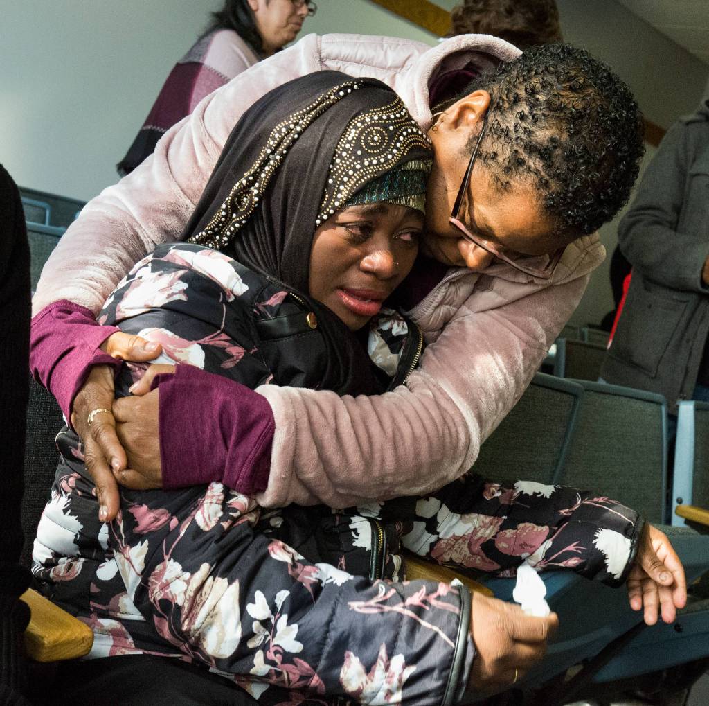 LaTonage Kelly, top, hugs the mother of victim Mohamed Adan after Anthony Hernandez-Cano is sentenced to life behind bars without the possibilty of parole, for the tortures and murders of two young men, at the Snohomish County Courthouse on Tuesday, Oct. 23, in Everett. Adan and Kellys son Ezekiel were both killed by Hernandez-Cano in July. (Andy Bronson / The Herald)