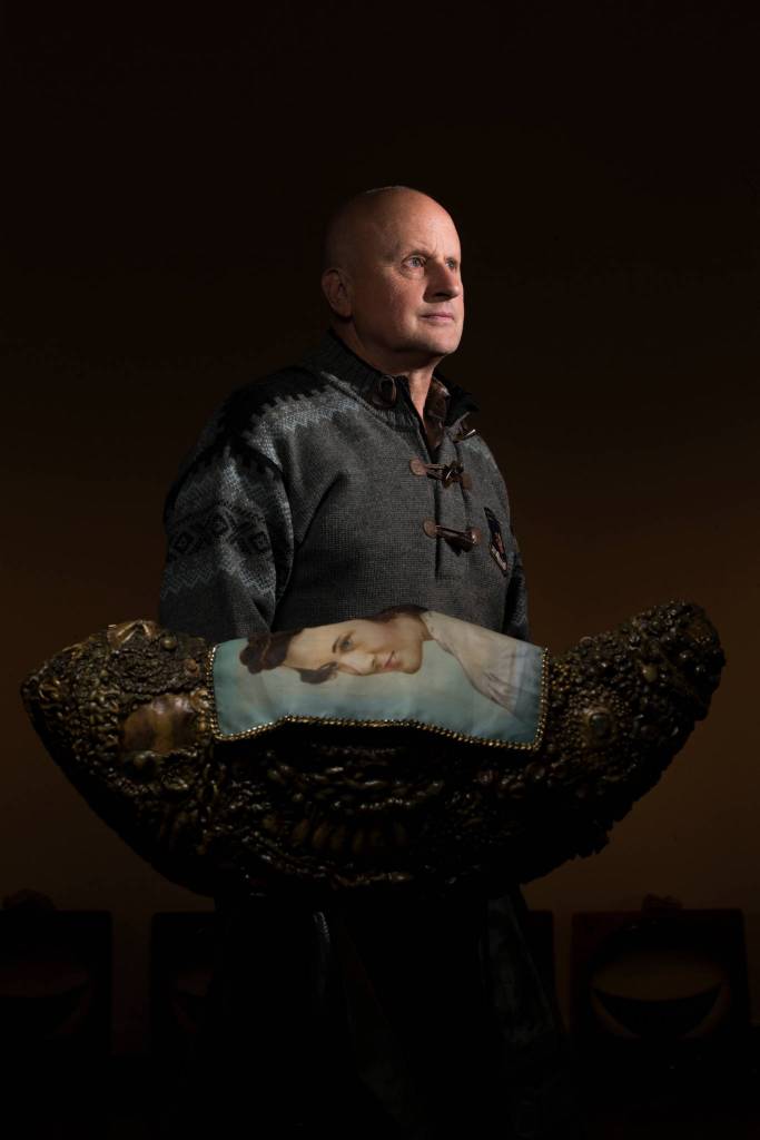 Artist Steve Jensen with his mothers shroud over her boat in his exhibit Voyager at the Schack Art Center on Wednesday, Sept. 26, in Everett. (Andy Bronson / The Herald)