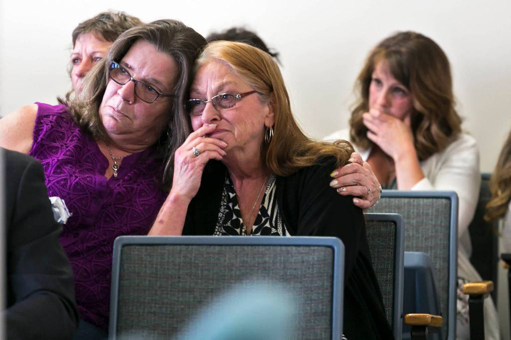 Janine Shaffer (center) is comforted by a loved on during the sentencing of her attacker, John Kuljis, Friday afternoon at the Snohomish County Courthouse in Everett on May 11. (Kevin Clark / The Herald)