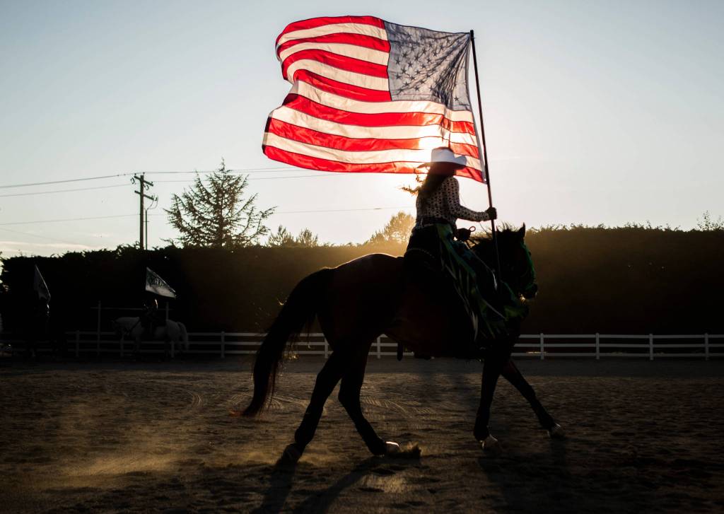 A member of the Stirrin Dust Drill Team practices in the outdoor arena before the start of the Pro-West Rodeo at the Evergreen State Fair on Sept. 1, in Monroe. (Olivia Vanni / The Herald)