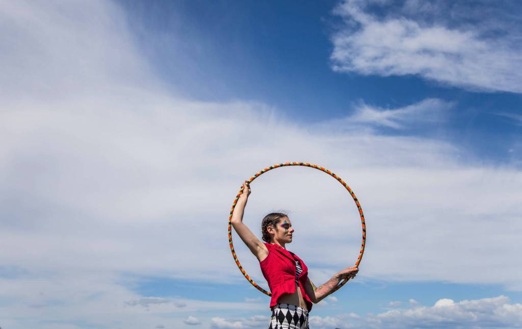 Kat Flows of Vuelta La Luna circus troupe hula hoops outside of their tent during Kla Ha Ya Days on Saturday, July 21, in Snohomish. (Olivia Vanni / The Herald)