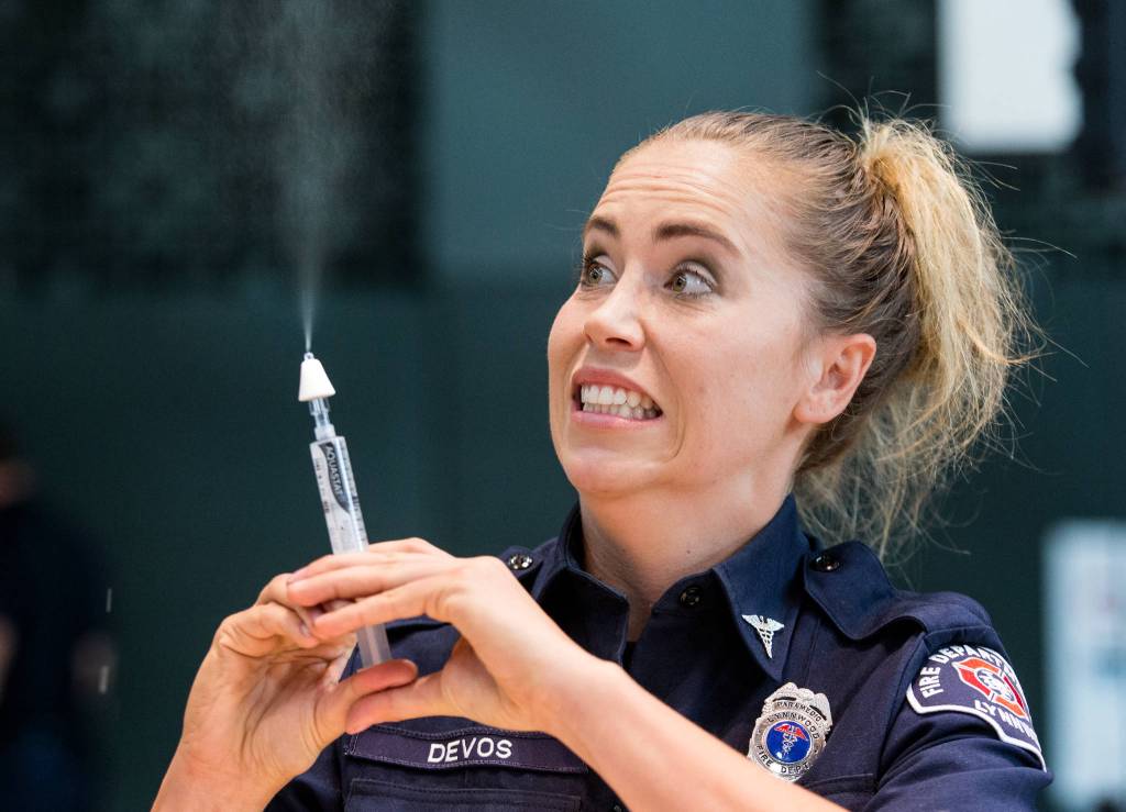 Lynnwood firefighter/paramedic Dani DeVos reacts as she as she teaches staff of Edmonds School District how to administer Narcan via a intranasal device during ACT Training at Edmonds-Woodway High School on Friday, Aug. 10, in Edmonds. (Andy Bronson / The Herald)
