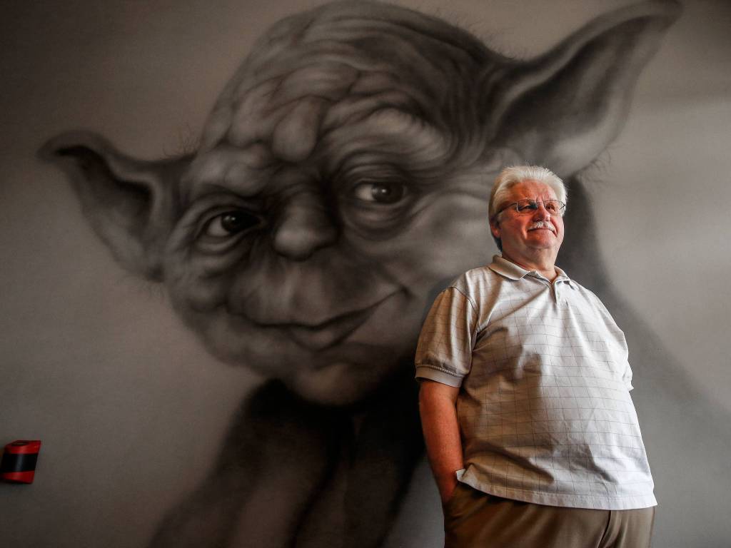 Silver Lake Video Owner, Perry Irvine, 67, takes pride in a number of charcoal airbrushed stars mounted in his store along with this bigger-than-life wall airbrush mural of Yoda. He says he had them done by a talented artist named Jim Noonan. (Dan Bates / The Herald)