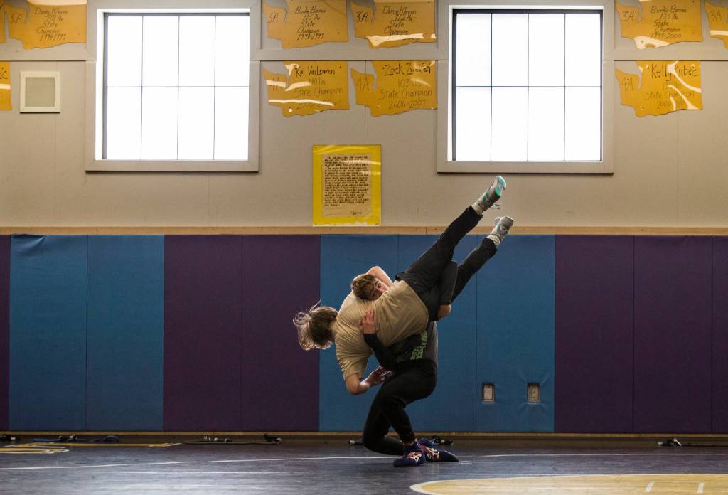 152 Hayden Long, Granite Falls, fr., gray pullover with W on back, black pants, purple/white shoes lifts up and takes down 126 Wyatt Springer, Cavalero, 8th as they work out at Lake Stevens High Schools wrestling room on Tuesday, June 5, in Lake Stevens. They will be representing Team Washington on the Cadet National Dual team that will compete for a national championship in Spokane in mid-June. (Andy Bronson / The Herald)