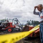 Bill Wojciechowski, a member of the Sky Valley Stock & Antique Tractor Club, looks out over the rubble of the barn that caught fire early Saturday morning at the Sky Valley Stock and Antique Tractor Show grounds on Saturday, Aug. 11, in Monroe. (Olivia Vanni / The Herald)