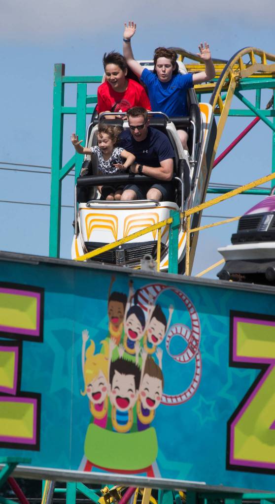 Riders seem to mimc the sign on The Zillerator as they enjoy a ride on the last day of the Evergreen State Fair on Monday, Sept. 3, in Monroe. (Andy Bronson / The Herald)