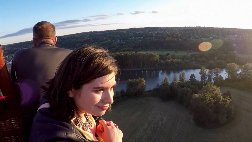 Emily Kennedy watches the scenery around her during a hot air balloon trip over Snohomish Valley on Sunday, June 24, in Snohomish. (Andy Bronson / The Herald)