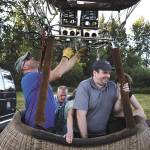 As pilot Jay Woodward fire hot air into the balloon, Mark VanAntwerp winces at the heat and noise it makes during liftoff of a hot air balloon on Monday, June 18, 2018 in Snohomish, Wa. Licensed by the Federal Aviation Administration, Woodward has been piloting hot air balloons for 20 years. (Andy Bronson / The Herald)