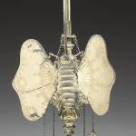 This unusual light, a Lucerne whale oil lamp, is made of brass and is silver plated. It gives the light from a small burning flame. The unusual shape coaxed a bid of $242. (Cowles Syndicate Inc.)