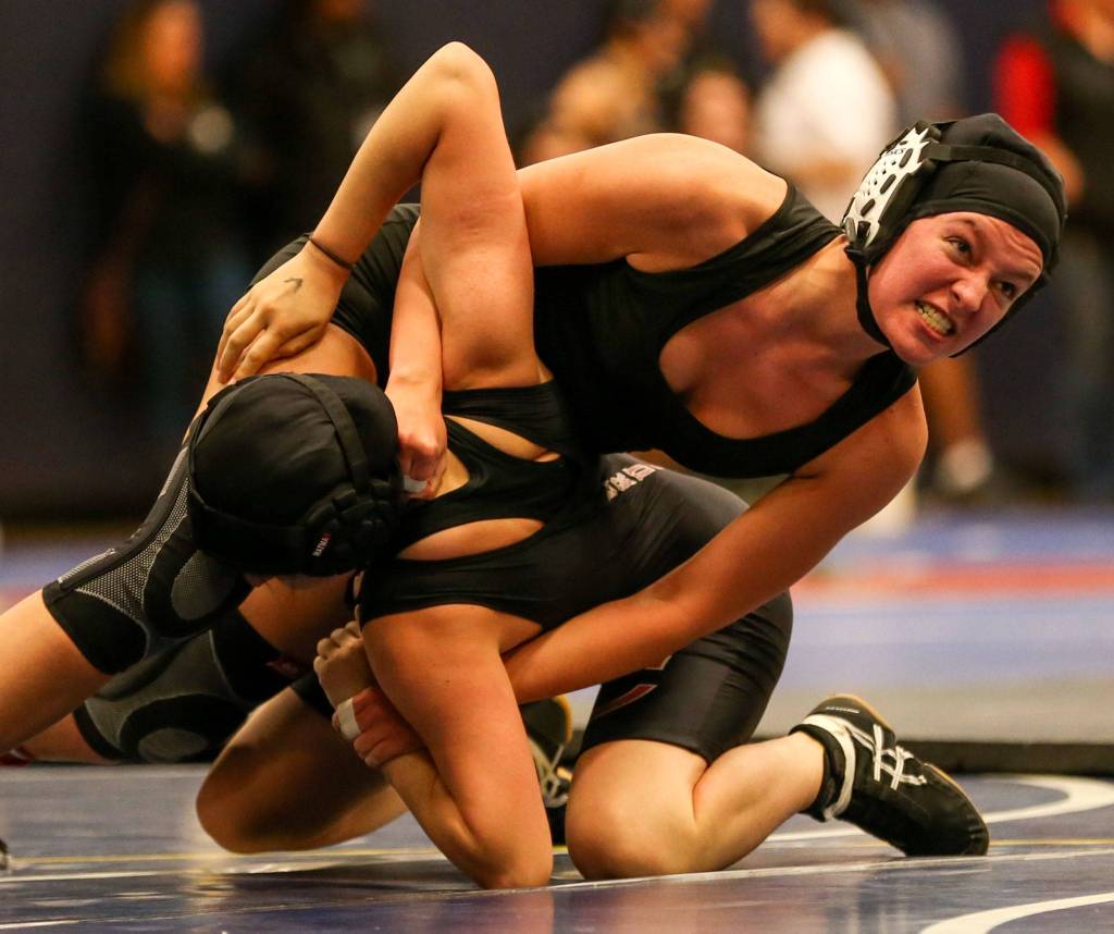 Kamiaks Sarah Giovi (right) wrestles Cascades Nadia Diaz Luna at Mariner High School in Everett on Dec. 19. (Kevin Clark / The Herald)