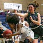 Chinas Mykila Burton gets a rebound in front of Edmonds-Woodways Maddie McMahon during the Top of the Peak Tournament at Glacier Peak High School in Snohomish on Dec. 27. Chiawana won 60-43. (Kevin Clark / The Herald)