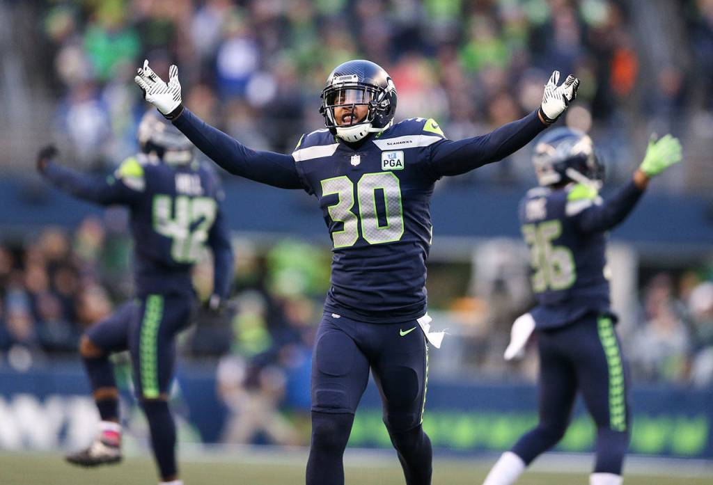 Seattles Bradley McDougald (30) celebrates a fourth-quarter turnover with teammates during the Seahawks 27-24 win over Arizona on Sunday at CenturyLink Field in Seattle. (Andy Bronson / The Herald)