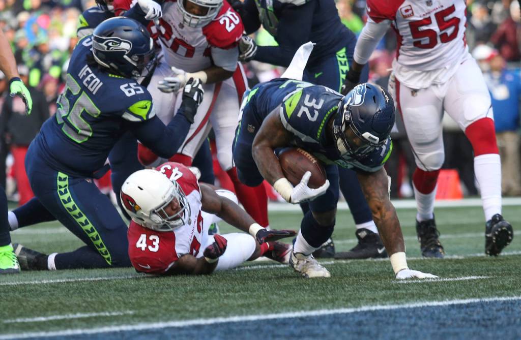 Seattles Chris Carson dives in for a touchdown during the Seahawks 27-24 win over Arizona on Sunday at CenturyLink Field in Seattle. (Andy Bronson / The Herald)