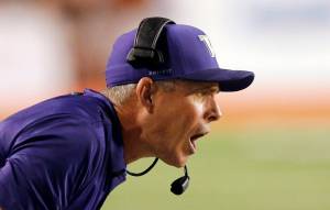 Rick Bowmer / Associated Press                                Washington football coach Chris Petersen shouts to his team in the second half of a game against Utah in September.