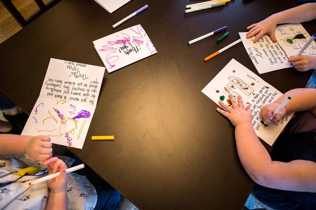 Kids draw on thank-you cards on for firefighters. (Olivia Vanni / The Herald)