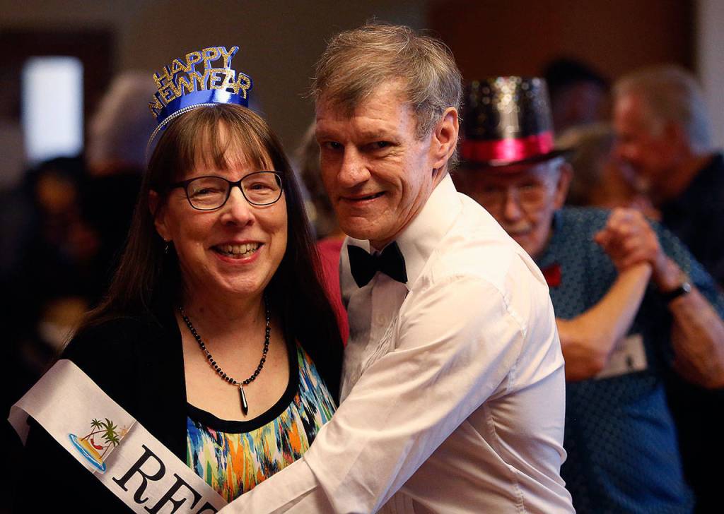 Marian Johnson, 65, retired on New years Eve after a decade as an office specialist at the Carl Gipson Senior center in Everett. She took a spin on the dance floor during Mondays party. (Dan Bates / The Herald)