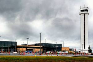 Workers continue to put finishing touches on the new Paine Field passenger terminal at the Snohomish County Airport Thursday. Commercial flights will start next month from the terminal, which is owned by Propeller Airports. (Dan Bates / The Herald)