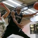 Lakewoods Michai Harris goes up for a layup as Marysville Getchells Chase Showalter defends during a non-conference game Wednesday in Marysville. Harris and the Cougars beat Showalter and the Chargers 62-54. (Kevin Clark / The Herald)