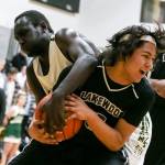 Lakewoods Morgan Stacey is fouled by Marysville Getchells Lul William during a non-conference game Wednesday in Marysville. Stacey and the Cougars beat William and the Chargers 62-54. (Kevin Clark / The Herald)