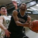 Lakewoods Michai Harris goes up for a layup as Marysville Getchells Chase Showalter defends during a non-conference game Wednesday in Marysville. Harris and the Cougars beat Showalter and the Chargers 62-54. (Kevin Clark / The Herald)
