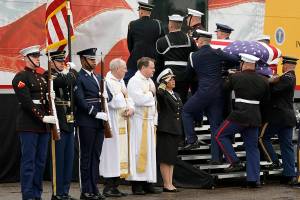 He’s the 6-foot-4 Marine in photos of Bush’s memorial services