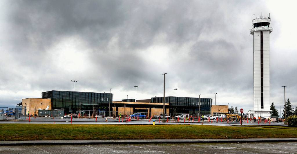 Workers continue to put finishing touches on the new Paine Field passenger terminal at the Snohomish County Airport. (Dan Bates / The Herald)