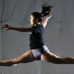 Shorecrest senior <a href="https://www.heraldnet.com/sports/qa-with-shorecrest-high-school-gymnast-victoria-collins/" target="_blank">Victoria Tory Collins</a> performs a split leap on the beam during practice at Cascade Elite Gymnastics on Dec. 19 in Everett. (Andy Bronson / The Herald)