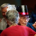 Lloyd Swanson, 94, and his dance partner Pat Williamson, 78, take a spin on the floor at the Carl Gipson Senior Center in Everett during the New Years Eve party Dec. 31. (Dan Bates / The Herald)