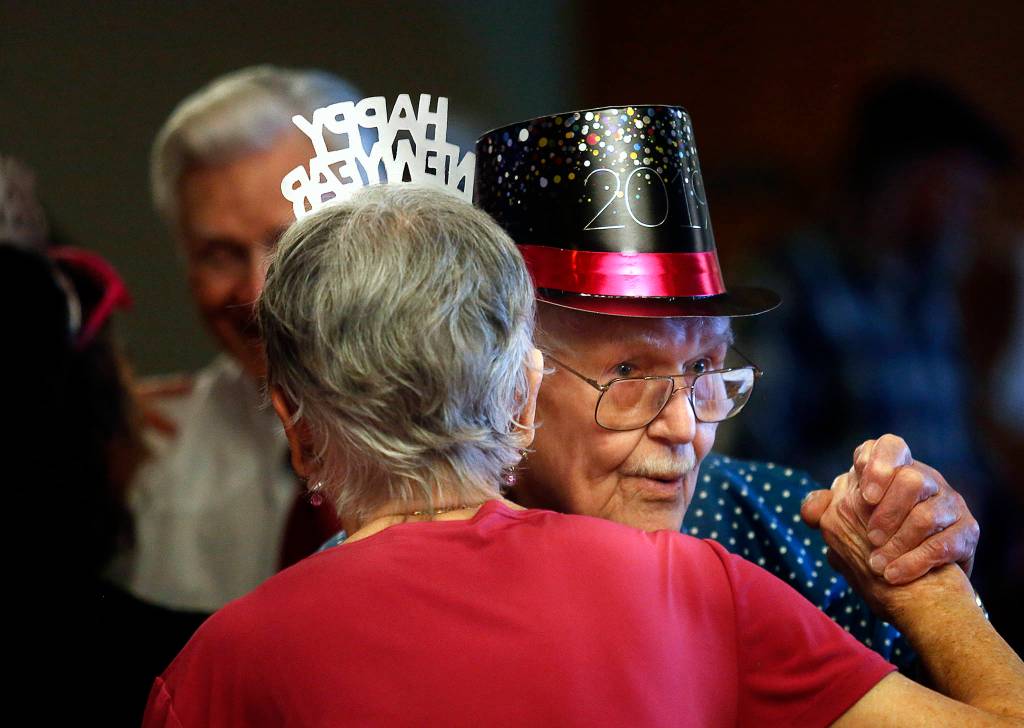 Lloyd Swanson, 94, and his dance partner Pat Williamson, 78, take a spin on the floor at the Carl Gipson Senior Center in Everett during the New Years Eve party Dec. 31. (Dan Bates / The Herald)