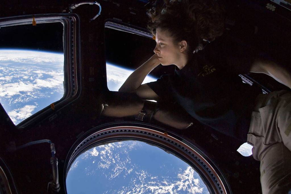 NASA astronaut Tracy Caldwell Dyson looks through a window in the International Space Station. Astronauts experiences inspired Bella Gaia. (NASA)