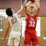 Mountlake Terraces Robbie Baringer (left) fouls Marysville Pilchucks Aaron Kalab during a Wesco 3A game Monday in Mountlake Terrace. Kalab and the Tomahawks beat Baringer and the Hawks 51-42. (Andy Bronson / The Herald)