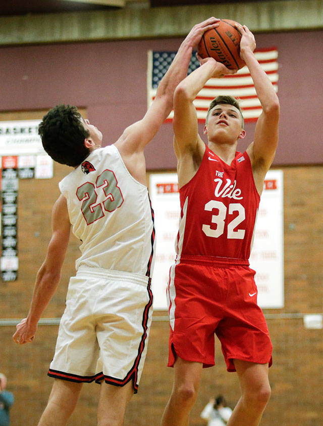 Mountlake Terraces Robbie Baringer (left) fouls Marysville Pilchucks Aaron Kalab during a Wesco 3A game Monday in Mountlake Terrace. Kalab and the Tomahawks beat Baringer and the Hawks 51-42. (Andy Bronson / The Herald)