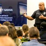 Officer Anthony Fletcher addresses the audience at a public meeting about gangs in September 2018 at Explorer Middle School in Everett. (Kevin Clark / The Herald)