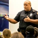 Officer Anthony Fletcher addresses the audience at a public meeting about gangs in September 2018 at Explorer Middle School in Everett. (Kevin Clark / The Herald)