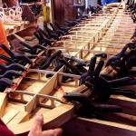 Heavy-duty clamps hold the rails tightly during the gluing process on the cedar-strip paddleboard. (Contributed Photo)