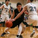 Arlingtons Josh Gutierrez tries to drive the baseline as Edmonds-Woodways Karsen Tjarneberg defends during a Wesco 3A boys basketball game Wednesday in Edmonds. Gutierrez scored a team-high 24 points for the Eagles, but Tjarneberg and the Warriors won 74-71. (Kevin Clark / The Herald)