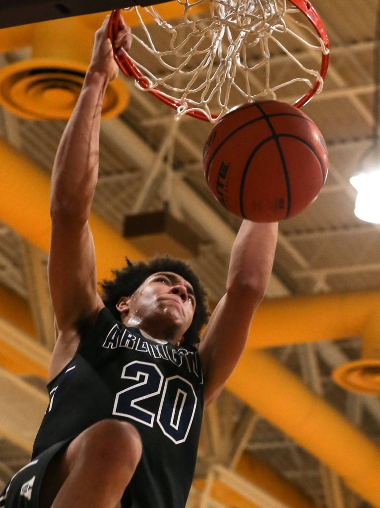 Arlingtons Will Abram dunks during a Wesco 3A boys basketball game at Edmonds-Woodway on Wednesday. The Warriors beat Abram and the Eagles 74-71. (Kevin Clark / The Herald)