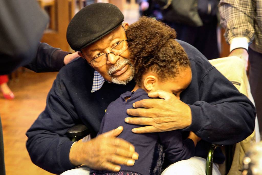 Carl Gipson gets a hug from his great-granddaughter, MyElli Richards, 4, during his birthday party Saturday afternoon at Carl Gipson Senior Center in Everett. (Kevin Clark / The Herald)