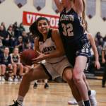 Archbishop Murphys Julia Lucas (left) works a post move with Arlingtons Makenzie Gage defending Friday night at Archbishop Murphy High School in Everett. The Wildcats won 58-49. (Kevin Clark / The Herald)