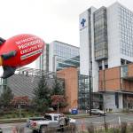 Employees with Providence Hospice and Homecare of Snohomish County raised a 24-foot inflatable rocket outside Providence Regional Medical Center Everett on Jan. 10. They wanted to draw attention to the high salaries many executives receive. (Lizz Giordano / The Herald)