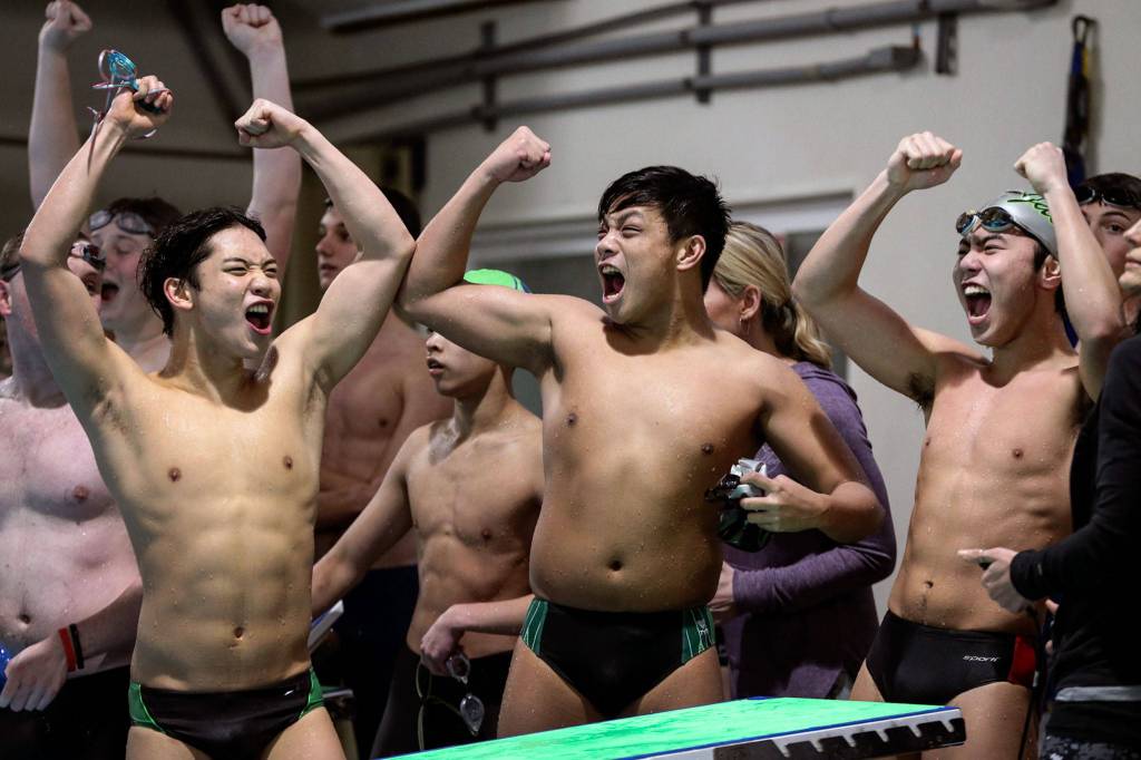 Jacksons (L-R)Tony Kim, Bastien Orbigo and Pryce Ulmemoto celebrate their first place finish in the 200-yard medley relay at West Coast Aquatics Pool in Mill Creek on Jan. 8. (Kevin Clark / The Herald)                                Jacksons Tony Kim, (left-right) Bastien Orbigo, and Pryce Ulmemoto celebrate their first place finish in the 200 yard medley relay Tuesday afternoon at West Coast Aquatics Pool in Mill Creek on January 8, 2019. (Kevin Clark / The Herald)