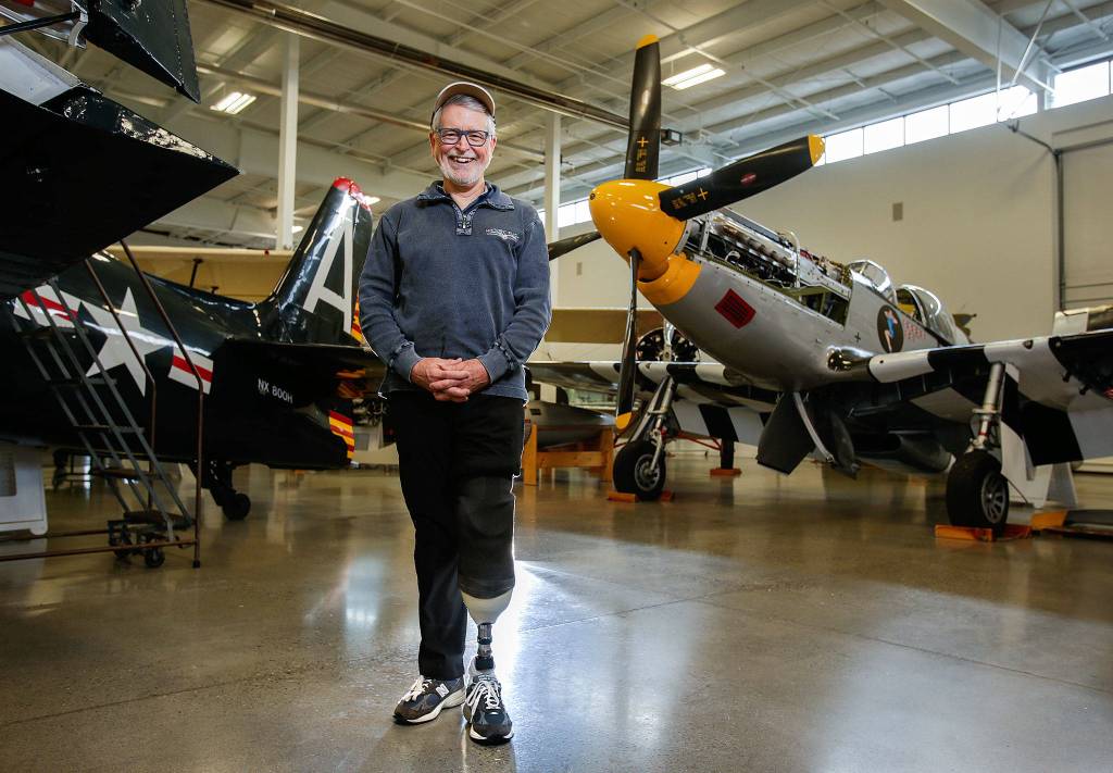 Wearing a prosthetic, Historic Flight Foundation president John Sessions talks about his airplane crash that cost him his left leg, on Dec. 21, 2018 in Everett. Sessions lost his left foot during an August crash while piloting a 1930s vintage biplane during an airshow in British Columbia. (Andy Bronson / The Herald)