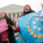 Margot Riphagen of New Orleans, Louisiana, wears a birth control pills costume during a protest in front of the U.S. Supreme Court in Washington on March 25, 2015. (AP Photo/Charles Dharapak, File)
