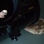 Physicist Joey Shapiro Key is seen through a Celestron telescope in her lab at the University of Washington Bothell campus. (Olivia Vanni / The Herald)