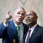 Gov. Jay Inslee (left) talks with Rep. John Lovick, D-Mill Creek, following Inslees State of the State address to a joint session of the Legislature on Tuesday in Olympia. (AP Photo/Elaine Thompson)